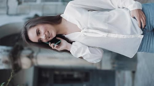 Young Woman Talking on Cellphone Outdoors