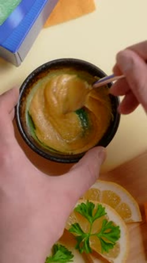 Mixing Mustard in Bowl with Lemon and Parsley