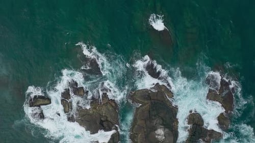 Waves Crash Against Rocks in the Ocean