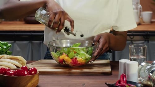 Woman Prepares Healthy Salad in Kitchen