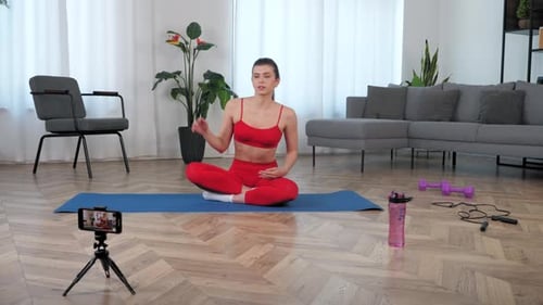 Young Woman Doing Yoga Stretches At Home