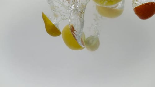 Assorted Fruit Slices Splashing in Water