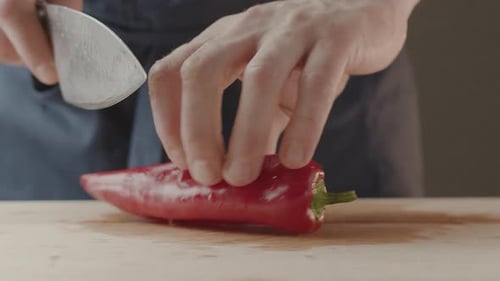 Chef Cuts Fresh Red Pepper with Knife