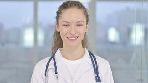Young Female Doctor Smiling in Hospital Close Up