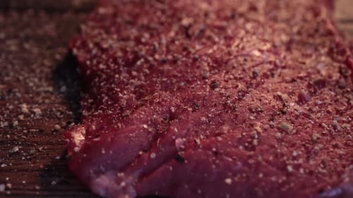 Seasoned Raw Steak on a Wooden Surface