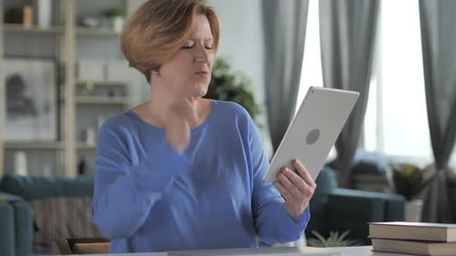 Woman Celebrates While Using Tablet