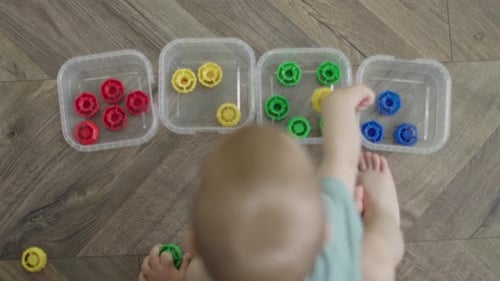 Baby Sorting Colorful Toys on Floor