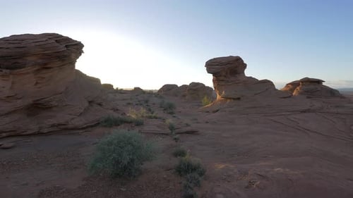 Sun shining behind rock formations