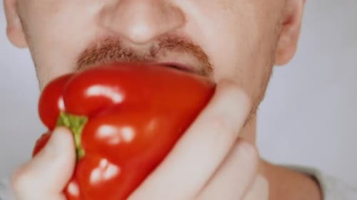 Close Up Face Fair Man Eats Bell Pepper