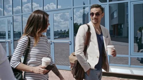 Group of Young Professionals Walking and Talking Outside