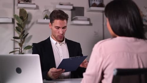 Interview is Conducted By Man in Suit for Woman in Office Spbi