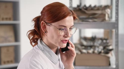 Woman Talking on Smartphone in Office Close Up
