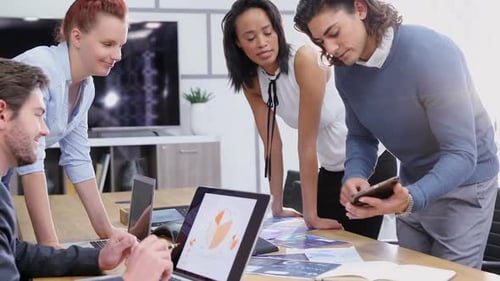 Diverse Team Collaborating on Data in Office