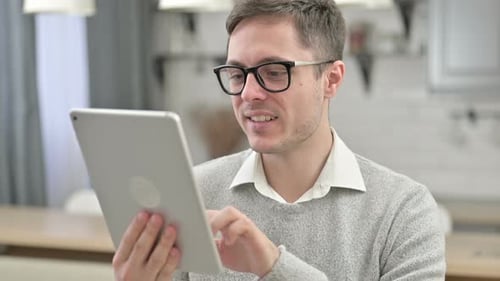 Young Adult Using Tablet at Home