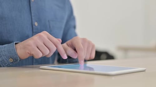 Hands Using Tablet Touchscreen at Desk Close Up