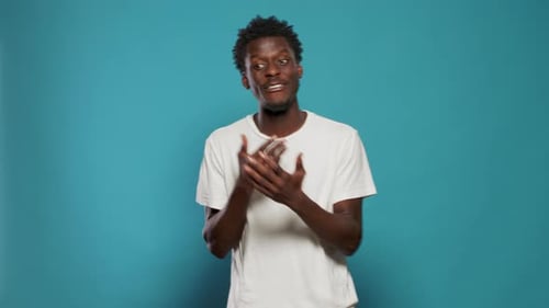 Angry Man Showing Emotions and Clenching Fists in Studio