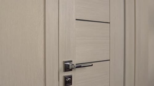 Masked Man Pointing Gun through Door Opening