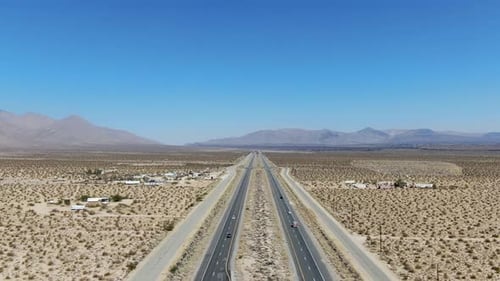 Aerial View of Road in the Middle of the Desert Under Blue Sky in California Desert