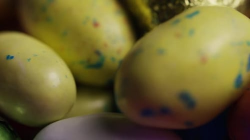 Rotating shot of colorful Easter candies on a bed of easter grass