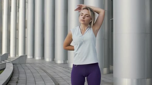 Woman Stretching Arms Before Workout in City