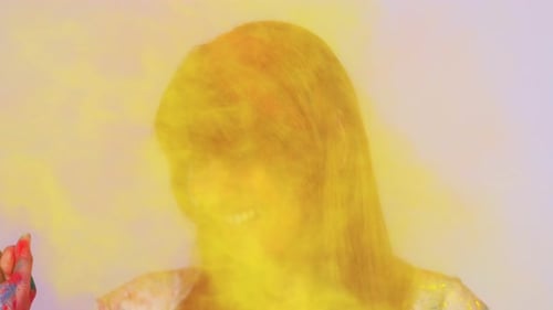 Beautiful Indian Student Woman Painted in Colors Celebrating Holi Festival in Studio White Isolate