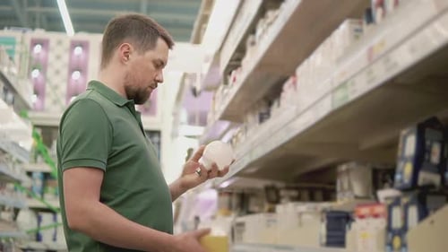 a Young Man Looks at a Light Bulb He Wants to Know How Many Watt There are