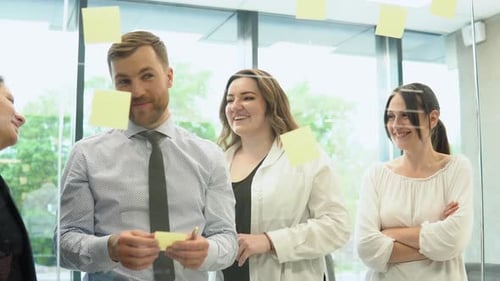 Group of Young Entrepreneurs Discussing Business in Company Meeting Room
