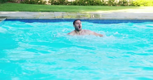 Man jumping into swimming pool