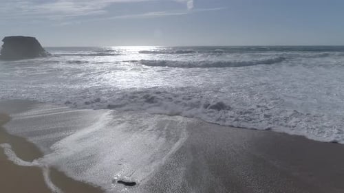 Ocean Waves Crashing on Sandy Beach Coastline