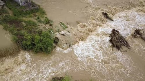 Aerial view of wide dirty river with muddy water in flooding period during heavy rains in spring.