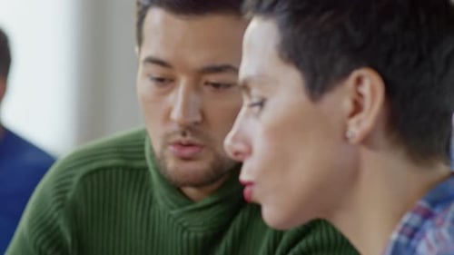 Colleagues Working Together on a Tablet in Office