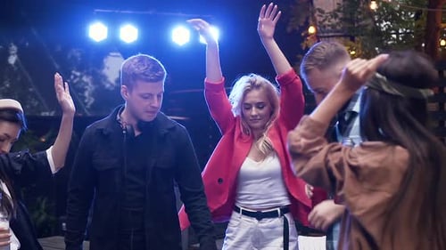 Young Adults Dancing at an Outdoor Party