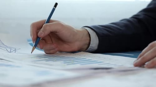 Businessman works with charts in office