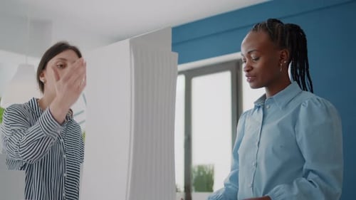 Close Up of Colleagues Looking at Building Model and Maquette to Plan Layout Details