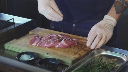 Chef Seasoning a Cut of Fresh Meat