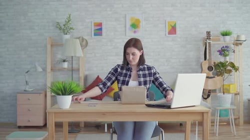 Woman opens birthday present at table