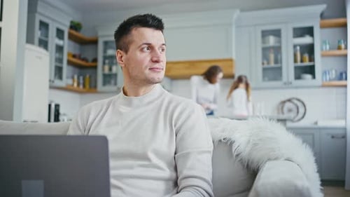 Close Up Portrait of Selfisolated Man Working on Laptop at Home Looking at Window Family on