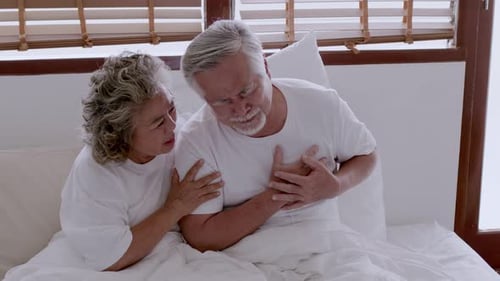 Senior Man Experiencing Chest Pain in Bed