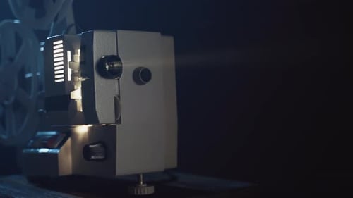 Vintage Film Projector Showing Movie in Dark Room