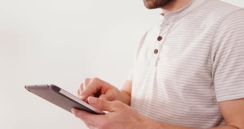 Man Using Tablet Device in Bright Room