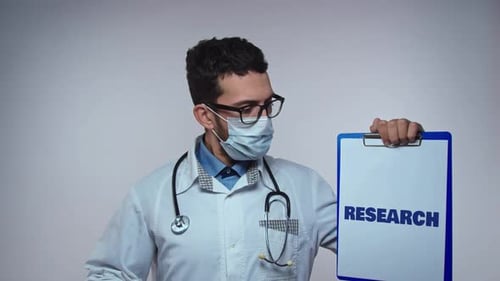 Doctor Holding Clipboard with Research in Hospital Setting