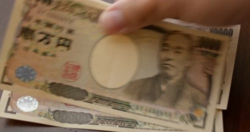 Japanese Yen Currency Displayed on Wooden Table