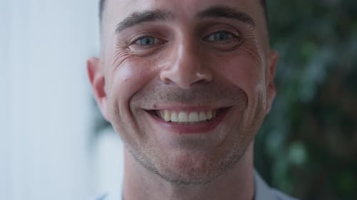 Headshot Portrait of Joyful Successful Confident Man with Toothy Smile Looking at Camera Smiling in