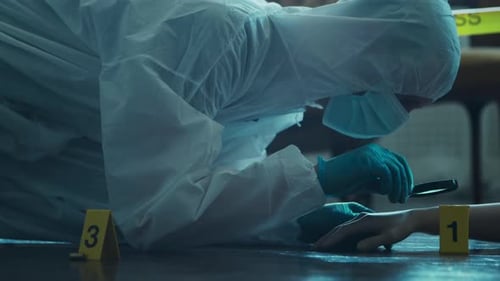 Investigator Examines Victim's Hand at Crime Scene