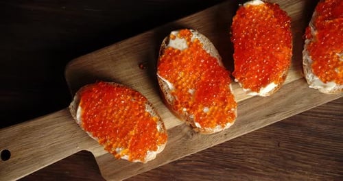 Caviar Sandwiches on a Wooden Cutting Board
