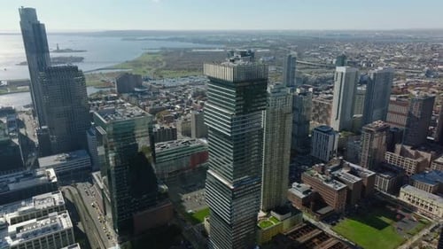 Ascending Aerial Shot of Tall Modern Apartment Building in City