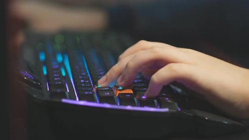 Close Up Young Gamer Hands Pushing Buttons on Keyboards, Working, Betting, Playing.