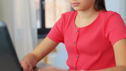 Girl Typing on Laptop Computer at Desk