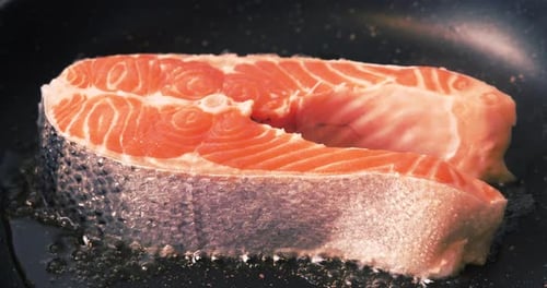 Salmon Steak Frying in a Pan Close Up