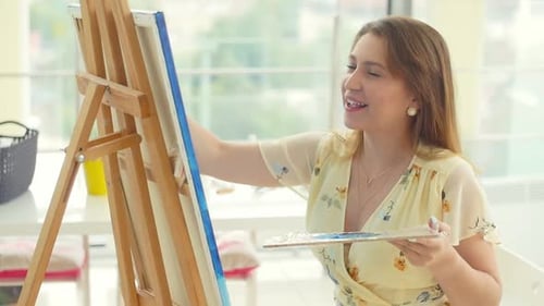 Female Artist Working at Her Workshop, Creating Beautiful Picture, Painting with Colorful Oils